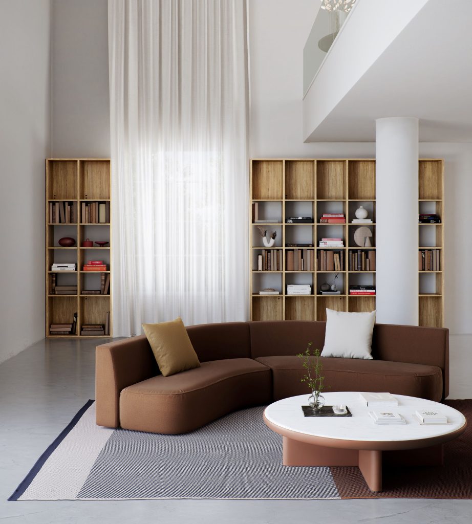 Witte ruitme met hoge plafond, boekenkast, ronde bank en ronde bijzettafel van Kettal