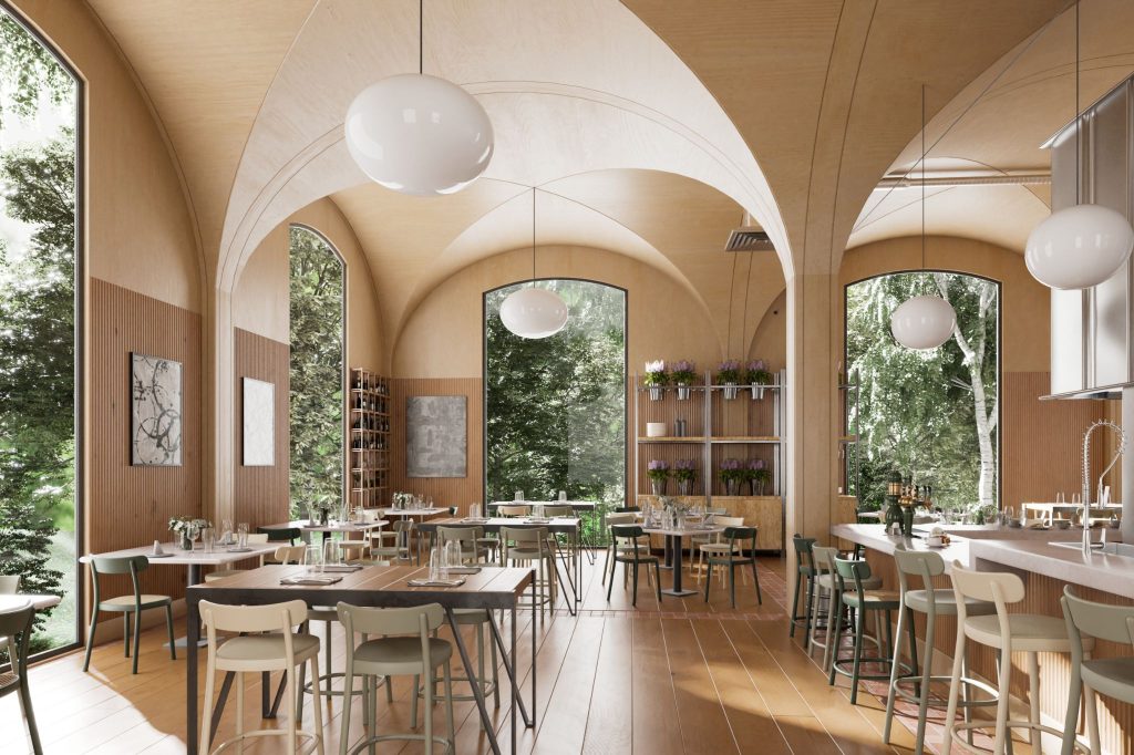 Groot gebouw met gebogen plafond en lange witte bolle lampen. Daaromheen zie je een aantal tafels en stoelen.